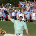 
              Rory McIlroy celebrates with the trophy after winning the Tour Championship golf tournament at East Lake Golf Club Sunday, Aug. 28, 2022, in Atlanta. (Jason Getz/Atlanta Journal-Constitution via AP)
            
