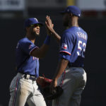 
              Texas Rangers' Leody Taveras, left, celebrates with Taylor Hearn, right, after defeating the Minnesota Twins in a baseball game, Sunday, Aug. 21, 2022, in Minneapolis. (AP Photo/Stacy Bengs)
            
