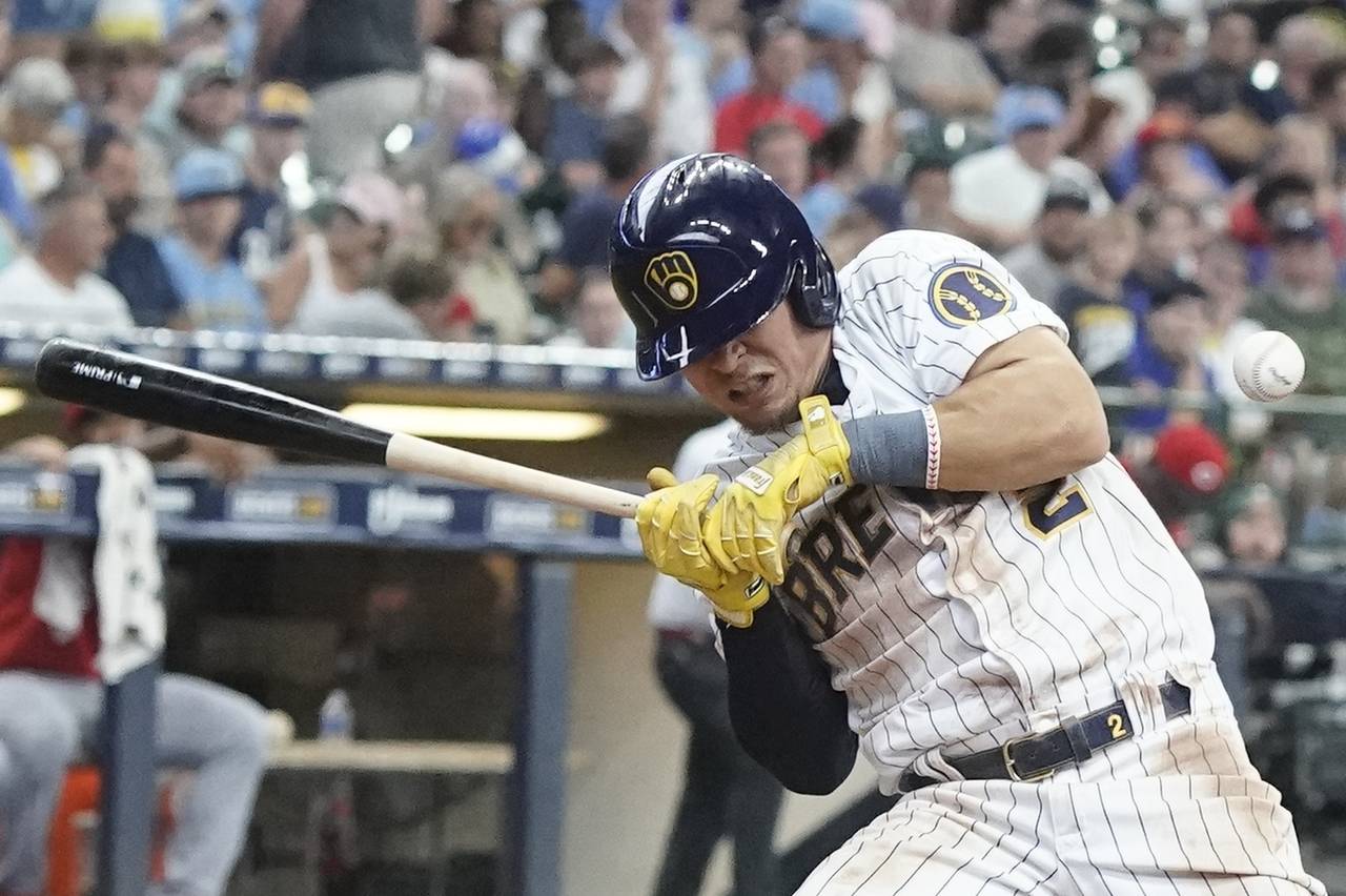 Milwaukee Brewers' Luis Uria is hit by a pitch during the seventh inning of a baseball game against...