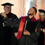 
              Golden State Warriors Stephen Curry tosses his cap in the air after his graduation ceremony at Davidson College on Wednesday, Aug. 31, 2022, in Davidson, N.C. Curry was also inducted into the school's Hall of Fame and his number and jersey were retired during the event. (AP Photo/Chris Carlson)
            