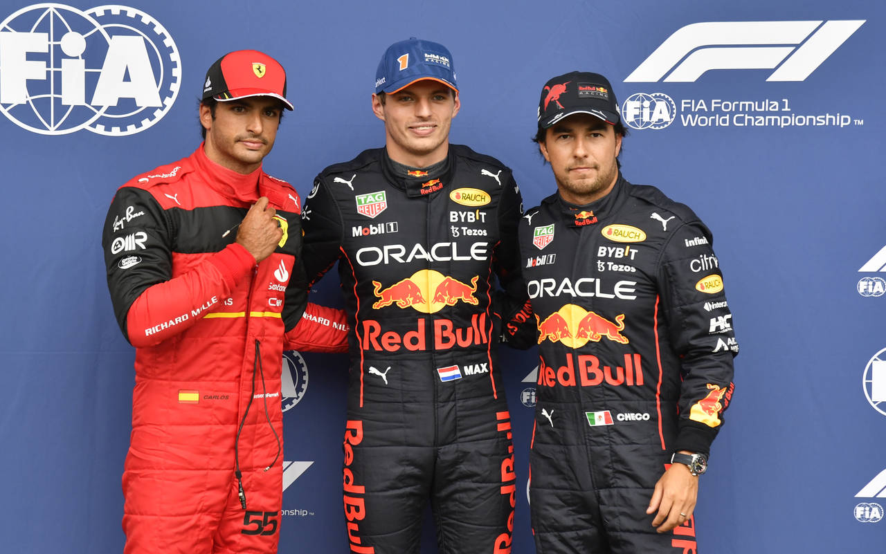 Red Bull driver Max Verstappen of the Netherlands, center, clocking the fastest time, poses with Fe...