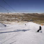 
              A snowboarder slides down the slope of the Afriski ski resort near Butha-Buthe, Lesotho, Saturday July 30, 2022. While millions across Europe sweat through a summer of record-breaking heat, Afriski in the Maluti Mountains is Africa's only operating ski resort south of the equator. It draws people from neighboring South Africa and further afield by offering a unique experience to go skiing in southern Africa. (AP Photo/Jerome Delay)
            