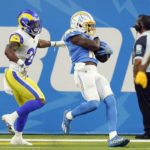 
              Los Angeles Chargers wide receiver Joe Reed (12) makes a touchdown catch next to Los Angeles Rams safety Terrell Burgess during the first half of a preseason NFL football game Saturday, Aug. 13, 2022, in Inglewood, Calif. (AP Photo/Mark J. Terrill)
            