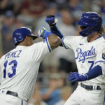 
              Kansas City Royals' Bobby Witt Jr. celebrates with catcher Salvador Perez after hitting a solo home run during the fourth inning of a baseball game against the Arizona Diamondbacks Tuesday, Aug. 23, 2022, in Kansas City, Mo. (AP Photo/Charlie Riedel)
            