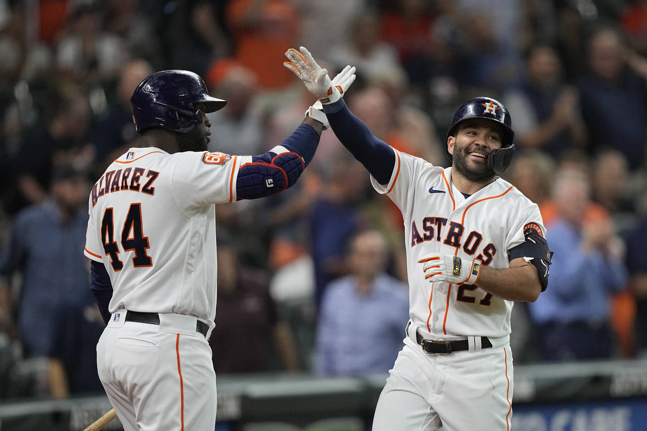Houston Astros' Jose Altuve (27) celebrates with Yordan Alvarez (44) after hitting a home run again...