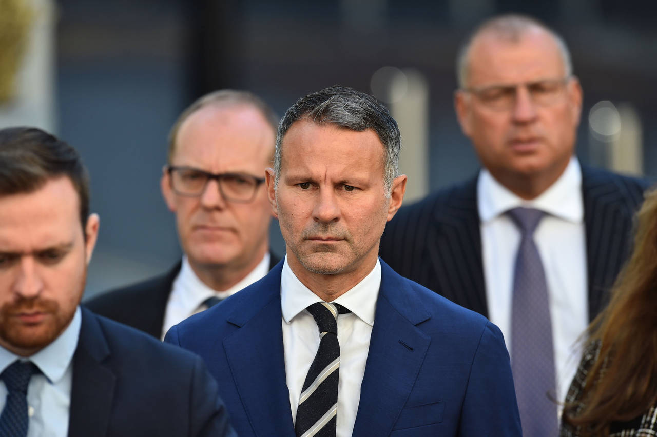 Former Manchester United footballer Ryan Giggs, centre, arrives at Manchester Crown Court, in Manch...