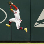
              Atlanta Braves right fielder Ronald Acuna Jr. (13) makes a leaping catch on a fly ball from Philadelphia Phillies' Bryson Stott in the second inning of a baseball game Wednesday, Aug. 3, 2022, in Atlanta. (AP Photo/John Bazemore)
            