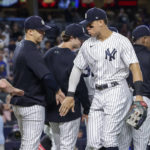 
              New York Yankees' Aaron Judge celebrates a win with teammate after a baseball game against the New York Mets, Monday, Aug. 22, 2022, in New York. (AP Photo/Corey Sipkin)
            