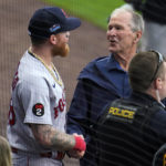 Former President George W. Bush, right, visits with Boston Red Sox players  as he walks past their dugout during pre-game festivities before the MLB  Little League Classic baseball game between the Baltimore