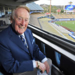
              FILE - In this Tuesday, Sept. 20, 2016, photo, broadcaster Vin Scully poses for a photo prior a baseball game between the Los Angeles Dodgers and the San Francisco Giants in Los Angeles. The Hall of Fame broadcaster, whose dulcet tones provided the soundtrack of summer while entertaining and informing Dodgers fans in Brooklyn and Los Angeles for 67 years, died Tuesday night, Aug. 2, 2022. He was 94. (AP Photo/Mark J. Terrill)
            