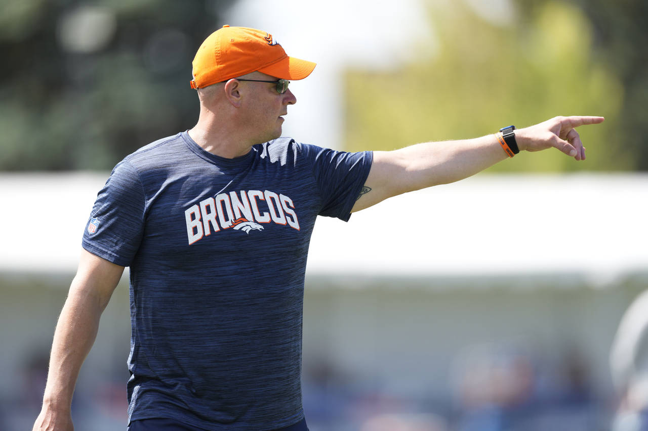 Denver Broncos head coach Nathaniel Hackett takes part in drills during an NFL football training ca...
