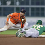 
              Houston Astros shortstop Jeremy Pena, left, catches Oakland Athletics designated hitter Ramon Laureano, right, who was trying to steal second base during the seventh inning of a baseball game Friday, Aug. 12, 2022, in Houston. (AP Photo/Kevin M. Cox)
            
