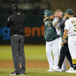 
              Oakland Athletics relief pitcher Joel Payamps (30) is helped off the field after being hit by a ball on a single hit by New York Yankees' Kyle Higashioka during the eighth inning of a baseball game in Oakland, Calif., Thursday, Aug. 25, 2022. (AP Photo/Godofredo A. Vásquez)
            