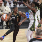 
              Las Vegas Aces guard Chelsea Gray (12) passes around Seattle Storm's Tina Charles during the first half of a WNBA basketball game Sunday, Aug. 14, 2022, in Las Vegas. (AP Photo/Sam Morris)
            