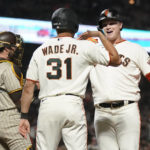 
              San Francisco Giants' Joc Pederson, right, celebrates after hitting a two-run home run that scored LaMonte Wade Jr. (31) as San Diego Padres catcher Austin Nola, left, looks on during the fourth inning of a baseball game in San Francisco, Monday, Aug. 29, 2022. (AP Photo/Jeff Chiu)
            