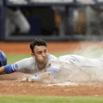 
              Kansas City Royals' Nicky Lopez scores on a sacrifice fly by Bobby Witt Jr., off Tampa Bay Rays relief pitcher Shawn Armstrong during the fifth inning of a baseball game Sunday, Aug. 21, 2022, in St. Petersburg, Fla. (AP Photo/Chris O'Meara)
            