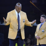 
              Bryant Young, left, a member of the Pro Football Hall of Fame Class of 2022, left, reacts after receiving his gold jacket from Edward DeBartolo Jr., right, during the gold jacket dinner in Canton, Ohio, Friday, Aug. 5, 2022. (AP Photo/Gene J. Puskar)
            