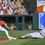 
              Boston Red Sox designated hitter J.D. Martinez slides into second base and avoids the tag from Baltimore Orioles second baseman Ramon Urias (29) for a double in the second inning of a baseball game, Saturday, Aug 20, 2022, in Baltimore. (AP Photo/Terrance Williams)
            