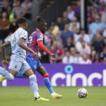
              Crystal Palace's Wilfried Zaha, background goes on to score his side's first goal of the game, during the English Premier League soccer match between Crystal Palace and Aston Villa, at Selhurst Park, London, Saturday, Aug. 20, 2022. (Zac Goodwin/PA via AP)
            