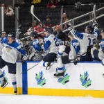 
              Finland celebrates a win over Sweden in a semifinal in the IIHF world junior hockey championships Friday, Aug. 19, 2022, in Edmonton, Alberta. (Jason Franson/The Canadian Press via AP)
            