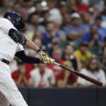 
              Milwaukee Brewers' Rowdy Tellez hits a two-run home run during the first inning of the team's baseball game against the Cincinnati Reds on Friday, Aug. 5, 2022, in Milwaukee. (AP Photo/Aaron Gash)
            
