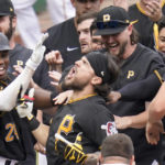 
              Pittsburgh Pirates' Michael Chavis, center, celebrates with teammates after Milwaukee Brewers reliever Matt Bush threw a wild pitch while he was batting, allowing Bryan Reynolds to score from third, in the 10th inning giving the Pirates the win in the baseball game, Thursday, Aug. 4, 2022, in Pittsburgh. The Pirates won 5-4.(AP Photo/Keith Srakocic)
            