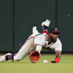 
              Atlanta Braves center fielder Michael Harris II makes a diving attempt for a ball hit for a triple by Colorado Rockies' Brendan Rodgers during the fourth inning of a baseball game Tuesday, Aug. 30, 2022, in Atlanta. (AP Photo/John Bazemore)
            