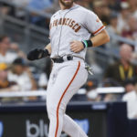 
              San Francisco Giants' Evan Longoria crosses home plate on a sacrifice fly hit by Thairo Estrada against the San Diego Padres during the fourth inning of a baseball game Monday, Aug. 8, 2022, in San Diego. (AP Photo/Mike McGinnis)
            