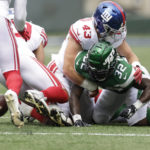 
              New York Jets running back Michael Carter (32) fumbles the ball before New York Giants linebacker Austin Calitro (59) recovers for a turnover in the first half of a preseason NFL football game, Sunday, Aug. 28, 2022, in East Rutherford, N.J. (AP Photo/Adam Hunger)
            