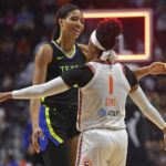 
              Connecticut Sun guard Odyssey Sims (1) embraces Dallas Wings forward Isabelle Harrison (20) after the Wings defeated the Sun 89-79 in a WNBA basketball first-round playoff series, Sunday, Aug. 21, 2022, in Uncasville, Conn. (Sean D. Elliot/The Day via AP)
            