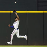 
              Texas Rangers center fielder Bubba Thompson catches a fly ball hit by Chicago White Sox's Andrew Vaughn during the second inning of a baseball game in Arlington, Texas, Saturday, Aug. 6, 2022. (AP Photo/LM Otero)
            