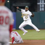 
              Oakland Athletics shortstop Elvis Andrus (17) throws to first base after forcing out Los Angeles Angels' Jo Adell (7) at second base on a double play hit into by Max Stassi during the fourth inning of a baseball game in Oakland, Calif., Monday, Aug. 8, 2022. (AP Photo/Jeff Chiu)
            