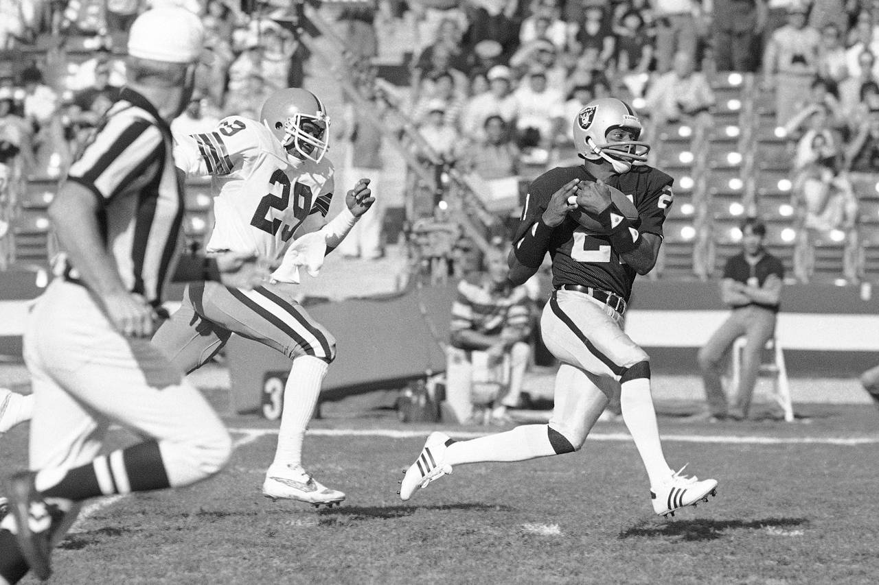 FILE - Los Angeles Raiders wide receiver Cliff Branch, right, catches a pass from quarterback Jim P...