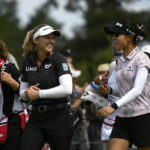 
              Canada's Brooke Henderson, center, and New Zealand's Lydia Ko, right, laugh as they walk on the fairway during the first round of the CP Women's Open golf tournament, Thursday, Aug. 25, 2022, in Ottawa, Ontario. (Justin Tang/The Canadian Press via AP)
            
