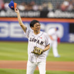 
              The Japanese consul-general in New York, Ambassador Mikio Mori, waves before throwing out a ceremonial first pitch before a baseball game between the New York Mets and the Colorado Rockies, Thursday, Aug. 25, 2022, in New York. (AP Photo/Frank Franklin II)
            