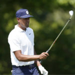 
              Tony Finau follows prepares to hit from the eighth tee during the second round of the St. Jude Championship golf tournament Friday, Aug. 12, 2022, in Memphis, Tenn. (AP Photo/Mark Humphrey)
            