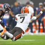 
              Cleveland Browns quarterback Jacoby Brissett (7) leaps as he gets a pass away in front of Chicago Bears linebacker Nicholas Morrow (53) during the first half of an NFL preseason football game, Saturday, Aug. 27, 2022, in Cleveland. (AP Photo/David Richard)
            
