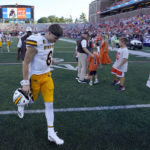 
              Wyoming quarterback Andrew Peasley walks off the field after his team's loss to Illinois in an NCAA college football game Saturday, Aug. 27, 2022, in Champaign, Ill. (AP Photo/Charles Rex Arbogast)
            