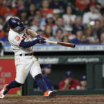
              Houston Astros' Jose Altuve hits a RBI double against the Texas Rangers during the fifth inning of a baseball game Tuesday, Aug. 9, 2022, in Houston. (AP Photo/David J. Phillip)
            