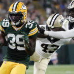 
              Green Bay Packers running back Tyler Goodson (39) carries against New Orleans Saints cornerback Quenton Meeks (43) and cornerback DaMarcus Fields during the first half of a preseason NFL football game Friday, Aug. 19, 2022, in Green Bay, Wis. (AP Photo/Morry Gash)
            