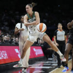
              Seattle Storm forward Stephanie Talbot (7) keeps a ball in bounds against Las Vegas Aces guard Jackie Young (0) during the first half in Game 2 of a WNBA basketball semifinal playoff series Wednesday, Aug. 31, 2022, in Las Vegas. (AP Photo/John Locher)
            