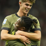
              AC Milan's Rafael Leao, bottom, celebrates with bis teammate Charles De Ketelaere after scoring his side's opening goal during a Serie A soccer match between AC Milan and Bologna at the San Siro stadium in Milan, Italy, Saturday, Aug. 27, 2022. (AP Photo/Luca Bruno)
            
