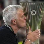 
              FILE - Roma's head coach Jose Mourinho kisses the Europa Conference League trophy at the end of the final soccer match between AS Roma and Feyenoord at National Arena in Tirana, Albania, on May 25, 2022. (AP Photo/Thanassis Stavrakis, File)
            