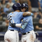 
              Tampa Bay Rays' Isaac Paredes embraces the Rays' David Peralta after hitting a two-run home run against the Los Angeles Angels during the third inning of a baseball game Thursday, Aug. 25, 2022, in St. Petersburg, Fla. (AP Photo/Scott Audette)
            