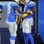 
              Los Angeles Chargers wide receiver Joshua Palmer (5) celebrates his touchdown catch with running back Isaiah Spiller (28) during the first half of a preseason NFL football game against the Dallas Cowboys Saturday, Aug. 20, 2022, in Inglewood, Calif. (AP Photo/Ashley Landis )
            