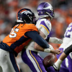 
              Denver Broncos defensive tackle McTelvin Agim (95) knocks the ball away from Minnesota Vikings quarterback Sean Mannion (14) during the first half of an NFL preseason football game, Saturday, Aug. 27, 2022, in Denver. The Broncos recovered the ball for a touchdown. (AP Photo/David Zalubowski)
            