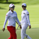 
              South Korea's Na Rin An walks behind fellow South Korean Hye-Jin Choi on the green of the first hole during the third round of the CP Women's Open golf tournament Saturday, Aug. 27, 2022 in Ottawa, Ontario. (Justin Tang/The Canadian Press via AP)
            