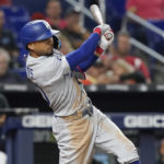 
              Los Angeles Dodgers' Mookie Betts (50) hits a two-run home run in the seventh inning of a baseball game against the Miami Marlins, Friday, Aug. 26, 2022, in Miami. (AP Photo/Marta Lavandier)
            