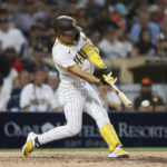 
              San Diego Padres' Ha-Seong Kim hits a double against the San Francisco Giants during the eighth inning of a baseball game, Monday, Aug. 8, 2022, in San Diego. (AP Photo/Mike McGinnis)
            
