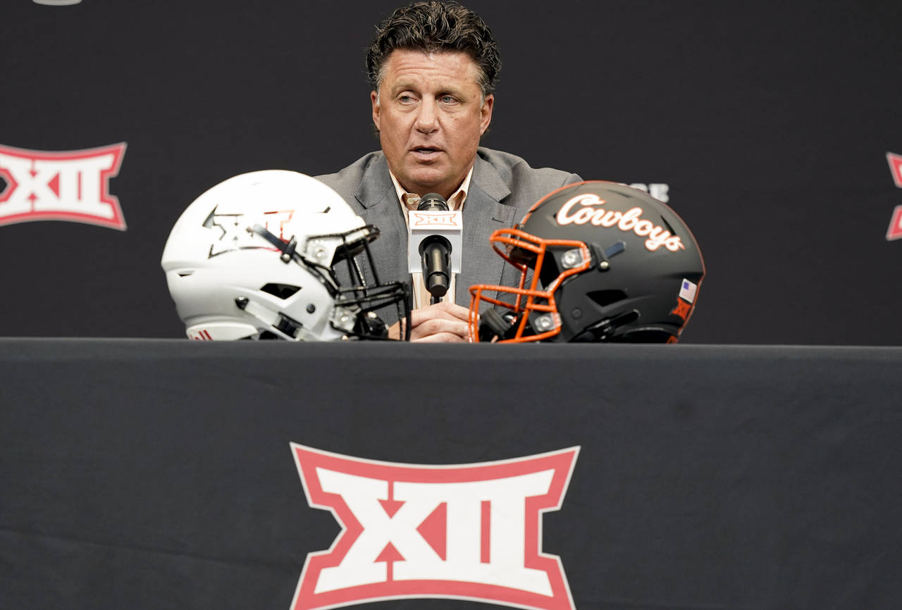 FILE - Oklahoma State head coach Mike Gundy answers a reporter's question at the NCAA college footb...